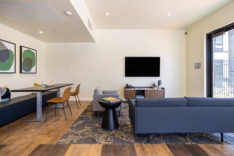 a living room with couches and a table and a television